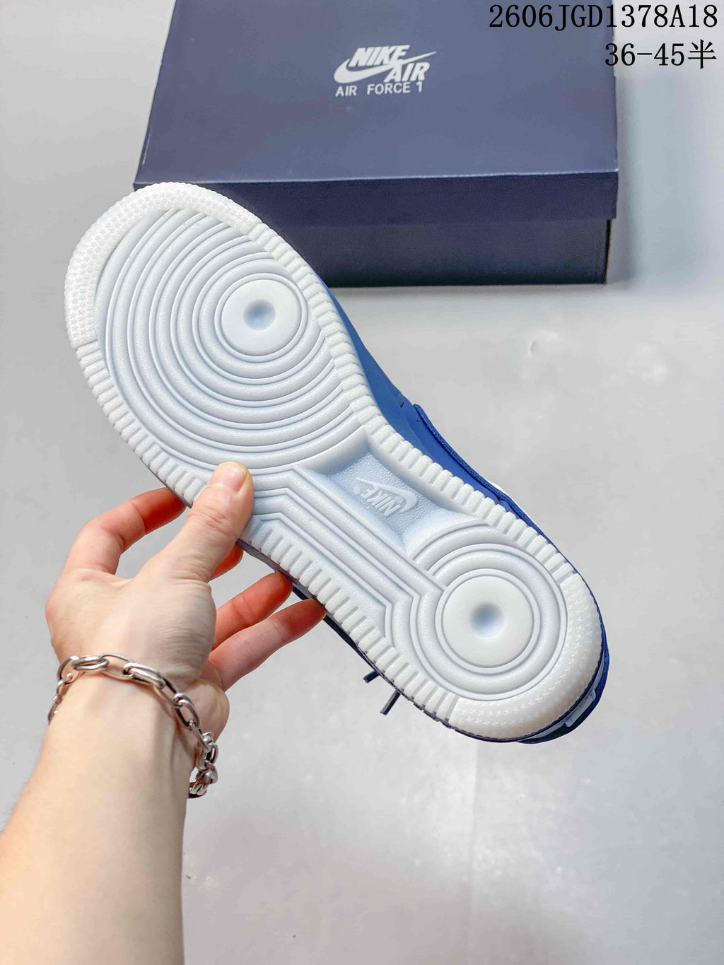 Underside of a sneaker showing a white circular-pattern outsole