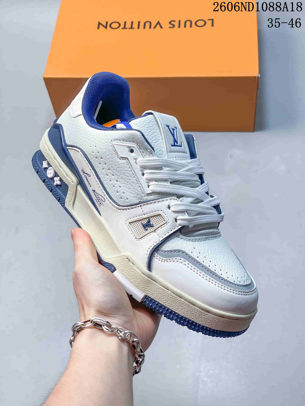 Angled view of a white low-top sneaker with blue accents and logo details