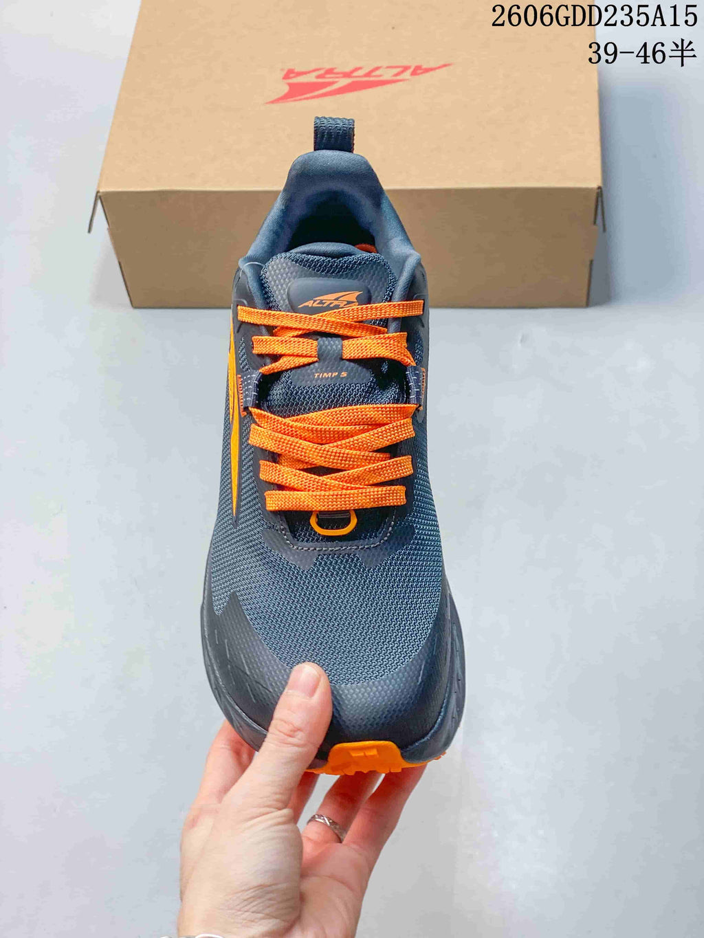 Top view showing the gray upper and bright orange laces.