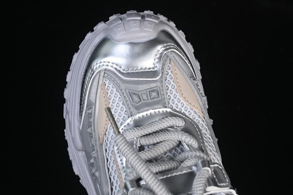 Top-down close-up of the sneaker’s toe and lace area