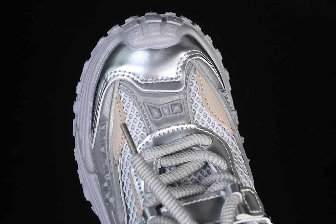 Top-down close-up of the sneaker’s toe and lace area