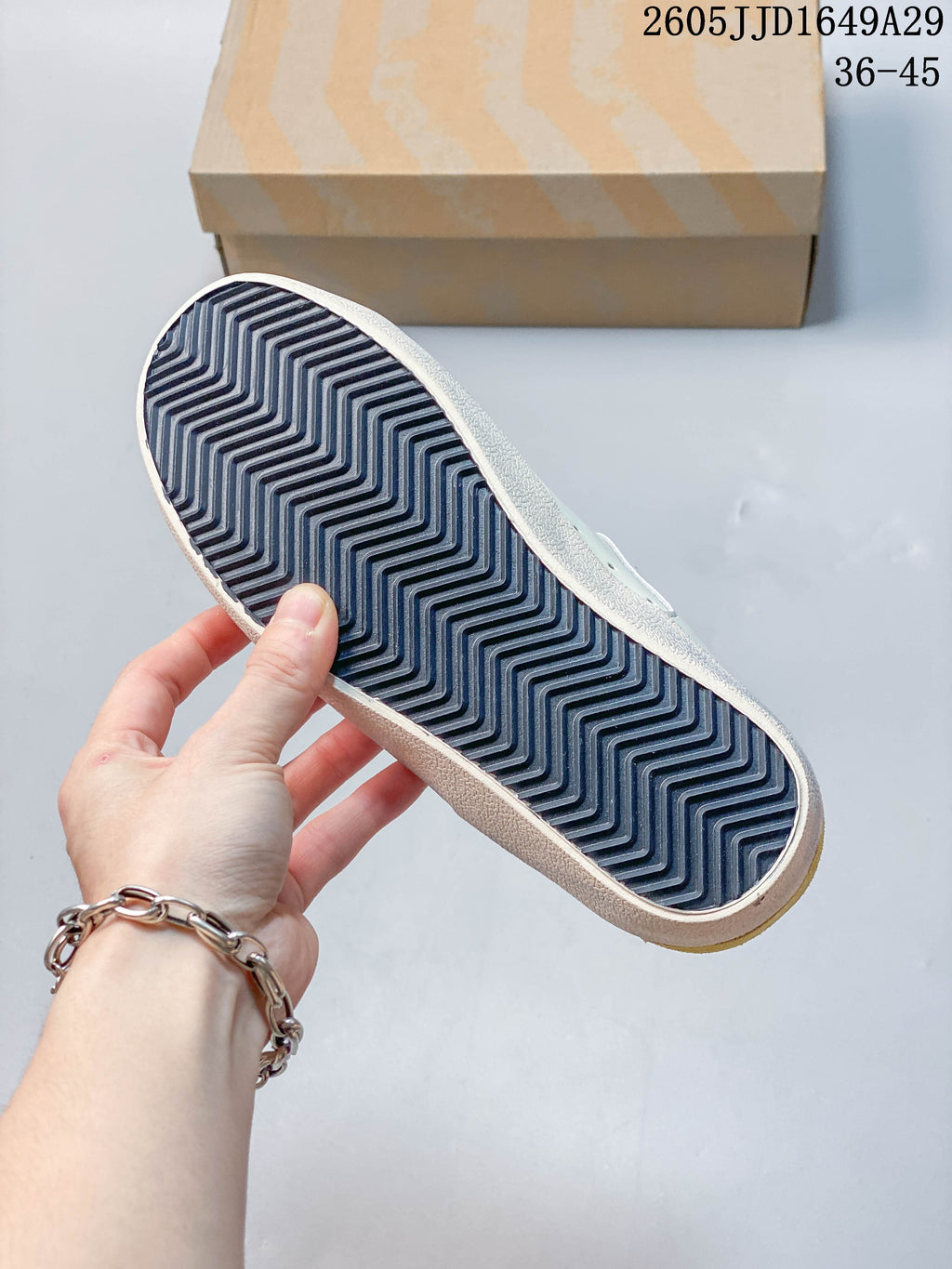 Close-up of the sneaker outsole with a dark zigzag tread pattern