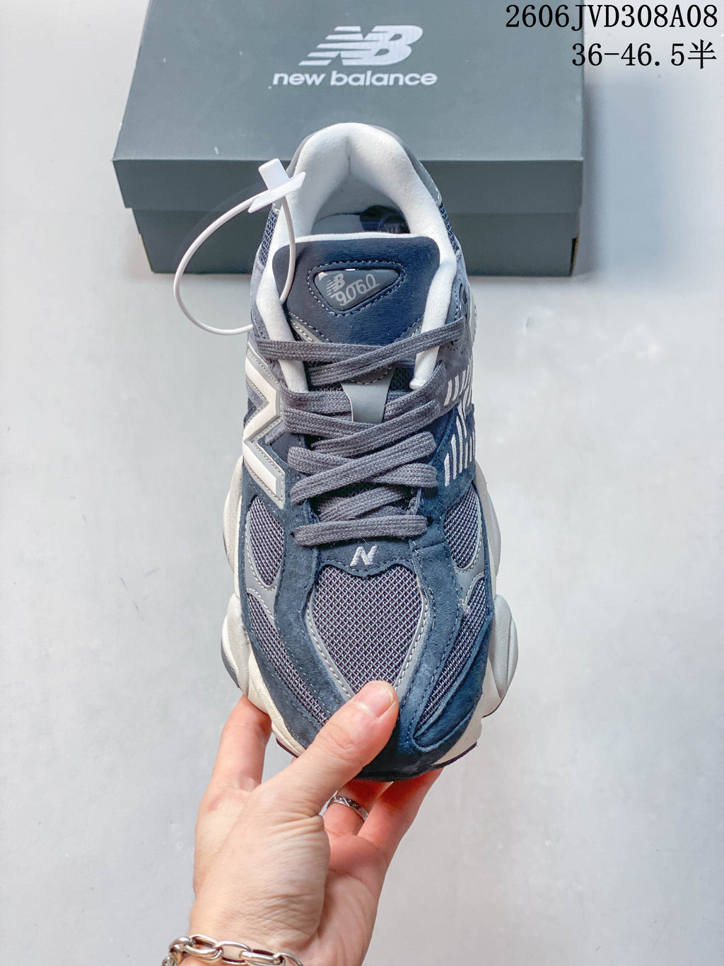 Front view of a blue-grey New Balance 9060 sneaker with laces and mesh panels
