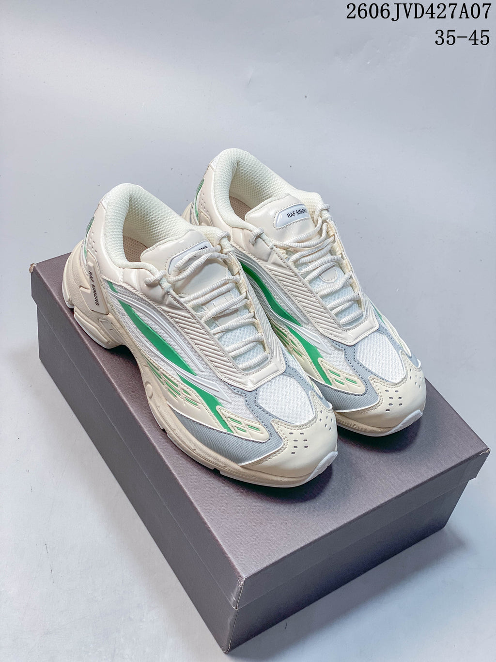 Pair of cream Raf Simons Cylon-21 sneakers with green and gray-blue accents