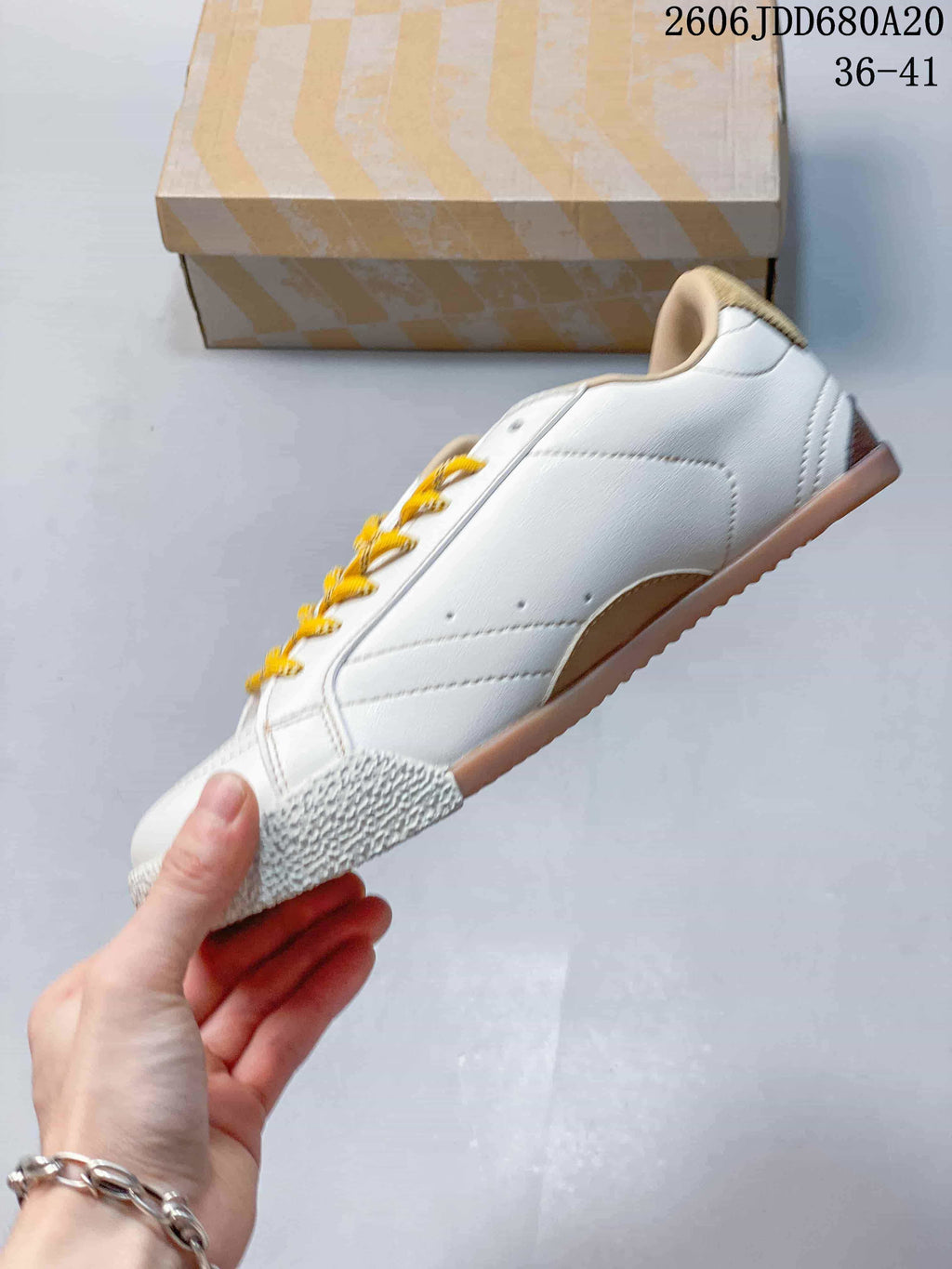 Side profile of the white low-top sneaker with yellow laces