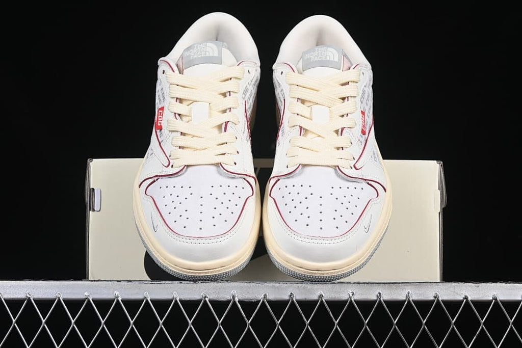 Front view of the pair showing perforated toe boxes, cream laces, and red trim.