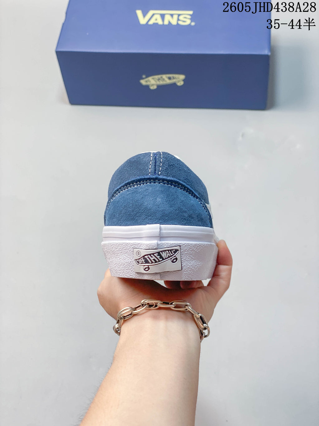 Rear view of the blue sneaker showing the heel and white sole