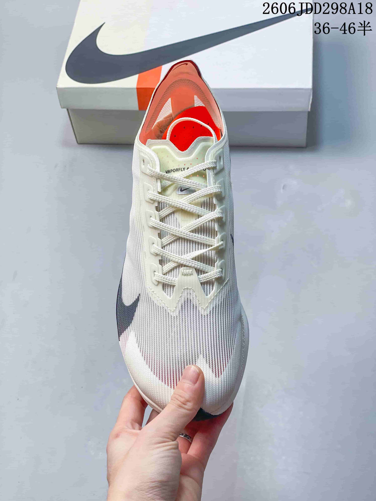 Top view of a cream Nike Vaporfly shoe showing the laces and orange interior
