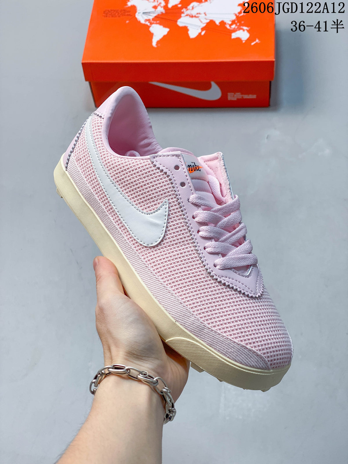 Angled side view of the pink sneaker with textured upper and cream-colored sole