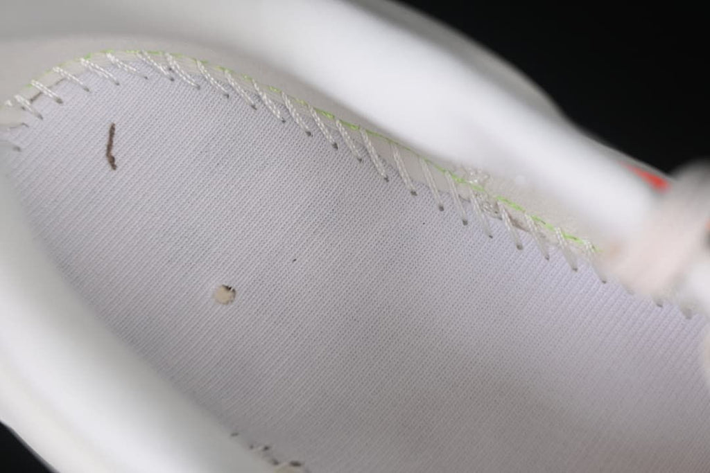 Close-up of stitching and the interior lining of the shoe.