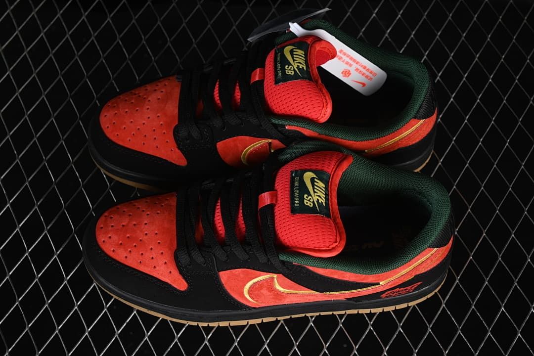 Pair of red-orange and black Nike SB Dunk Low sneakers shown from above and the side.