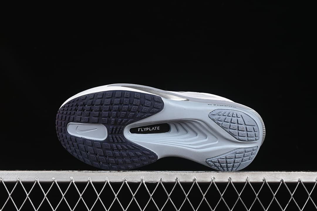 Underside view showing the patterned outsole and central FlyPlate marking.