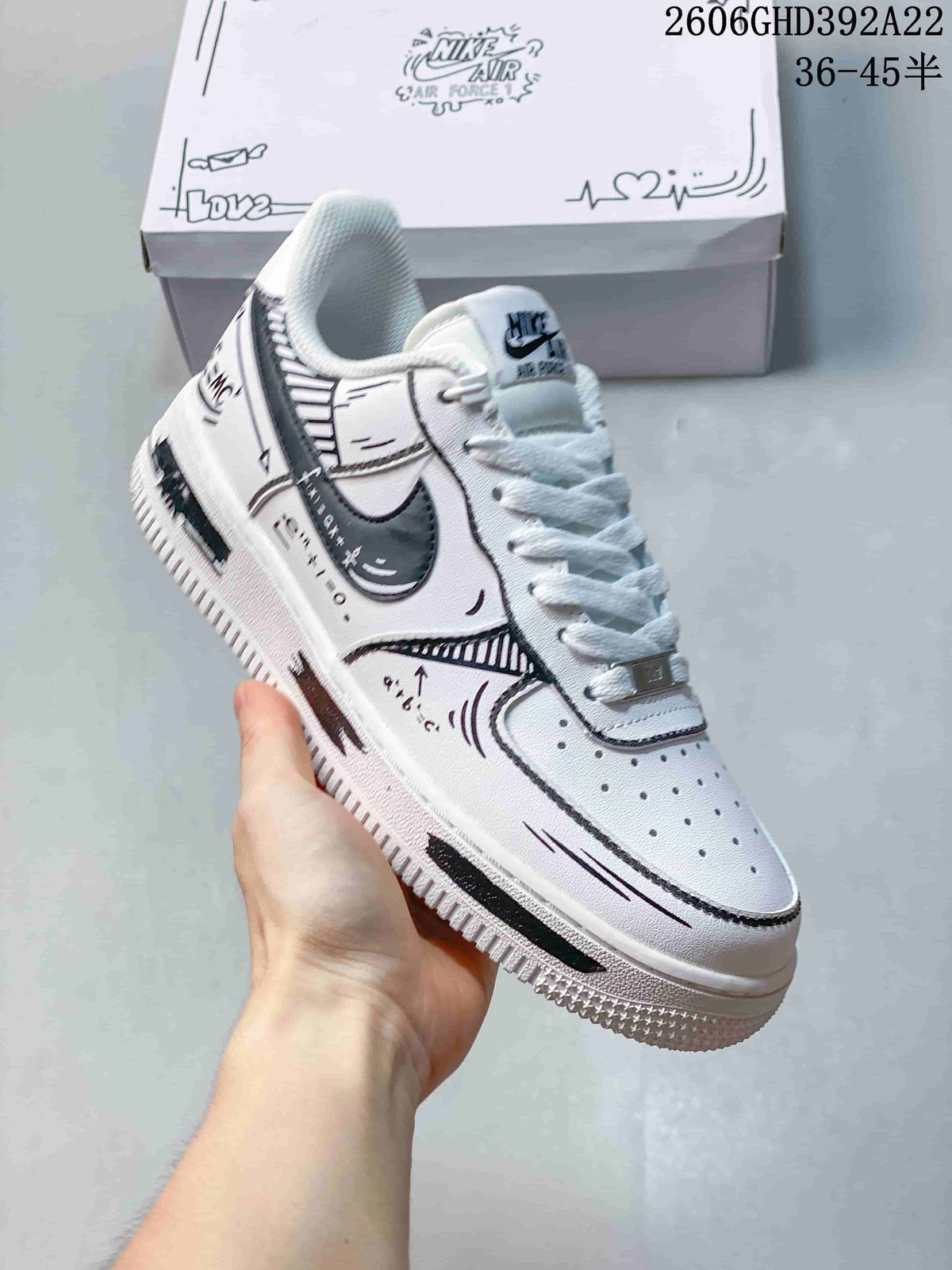 Angled side view of the white sneaker with black graphic accents and a dark swoosh.