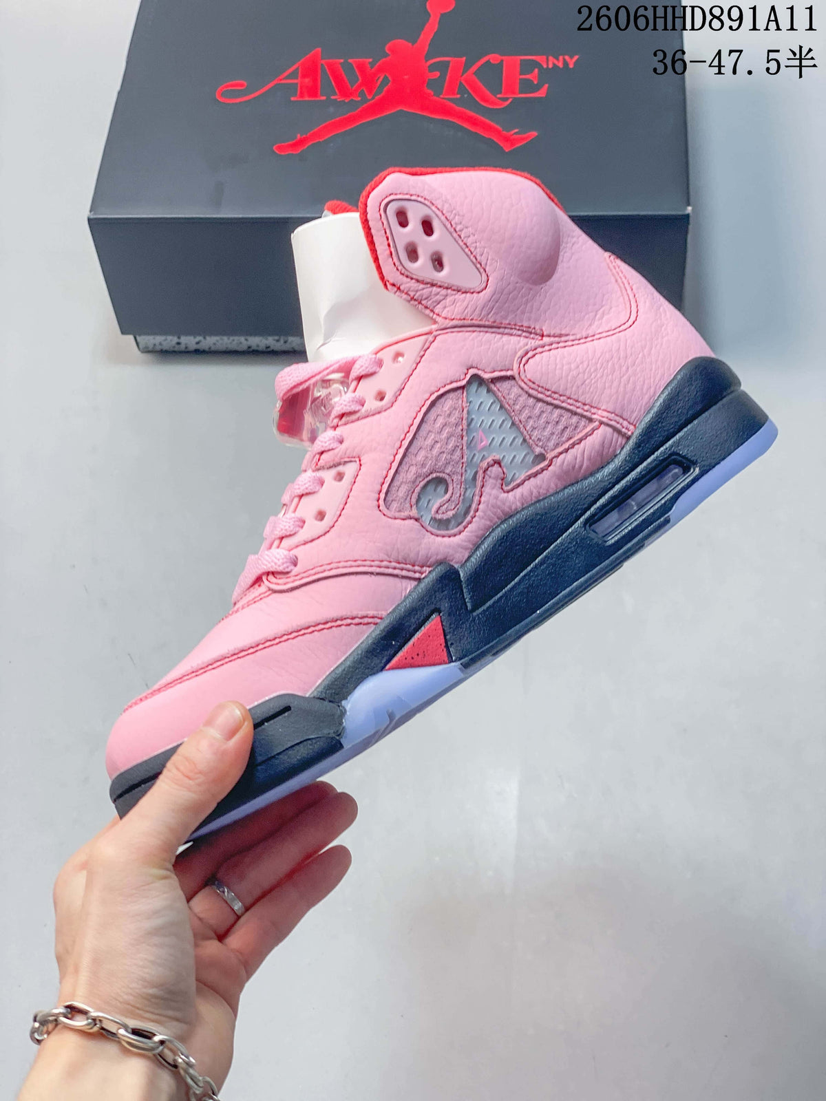 Side view of the pink mid-top sneaker with side panel detailing and a dark midsole.