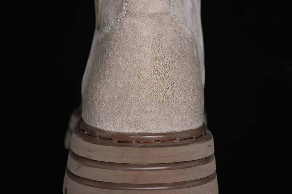 Rear view highlighting the boot's heel stitching and layered brown outsole