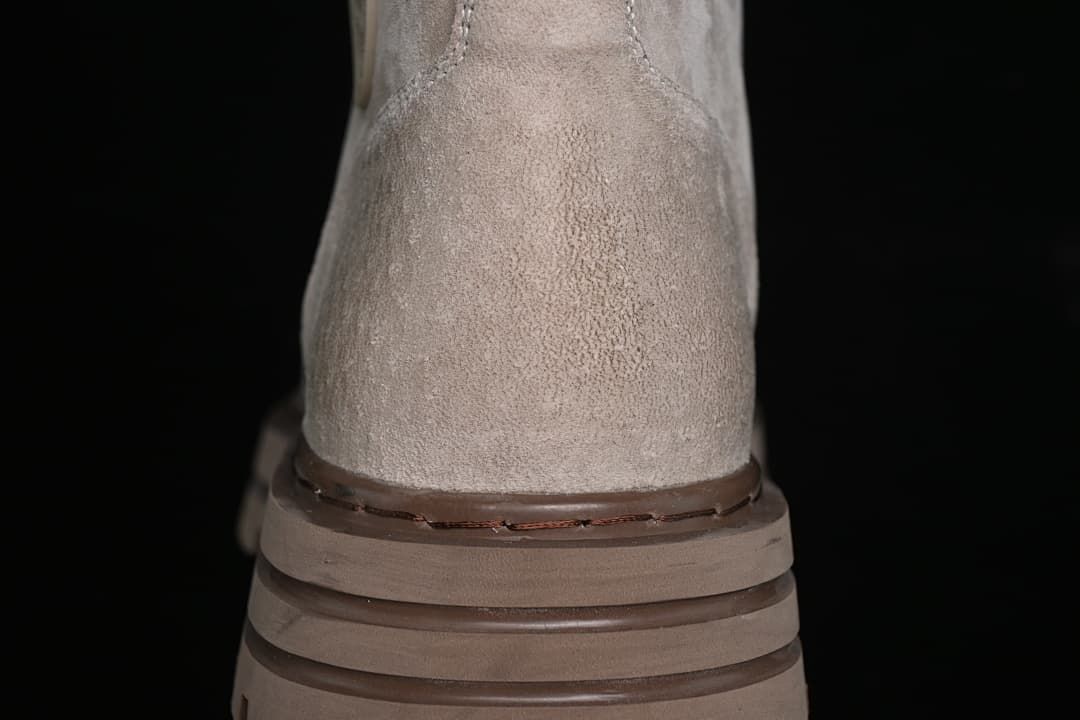 Rear view highlighting the boot's heel stitching and layered brown outsole