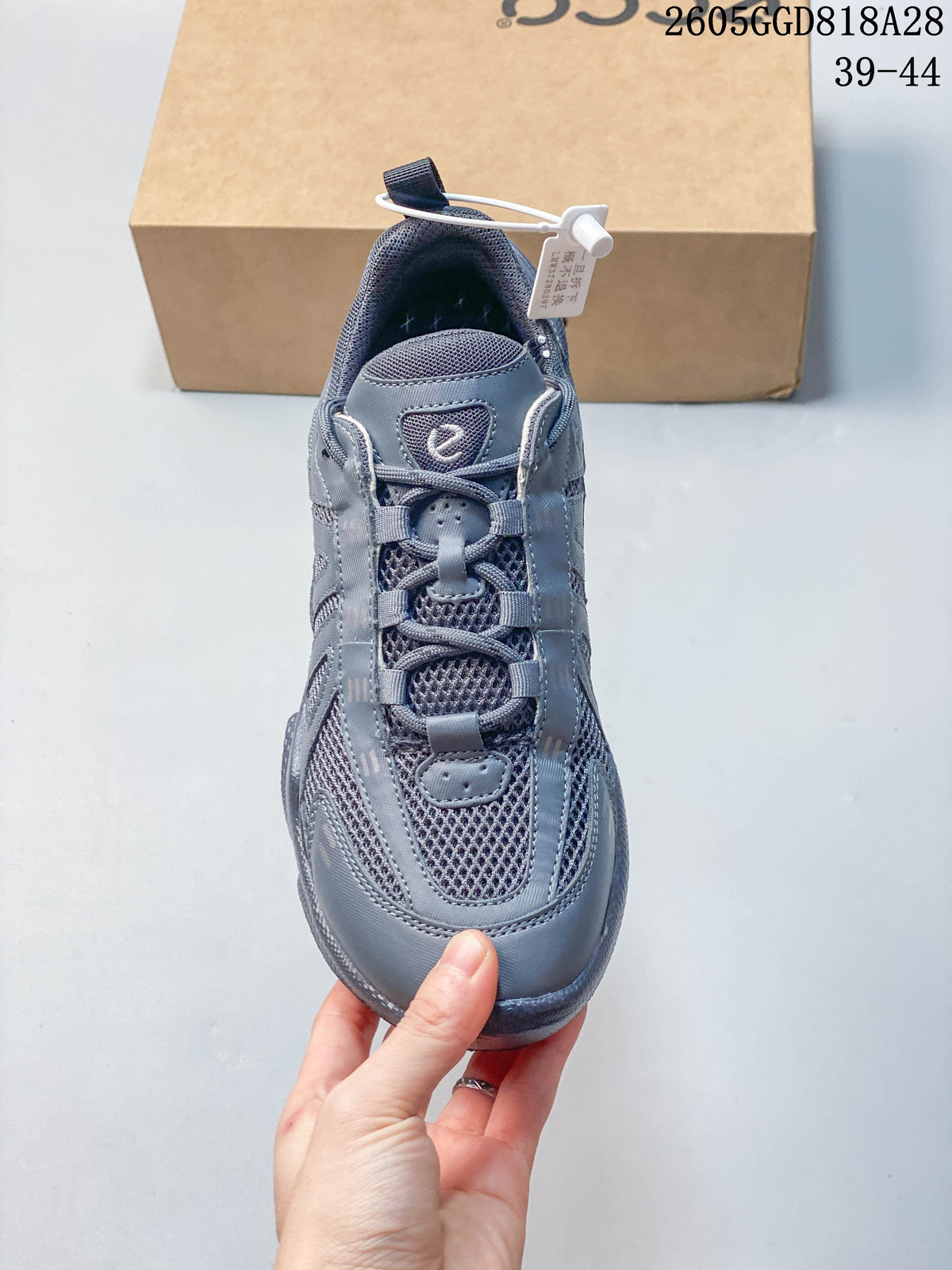 Front view of the gray sneaker showing its mesh upper and lace-up closure