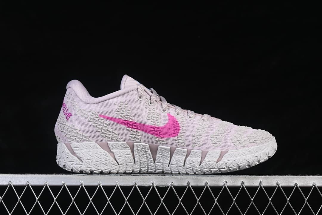 Side profile of the low-top basketball shoe with pink side swoosh