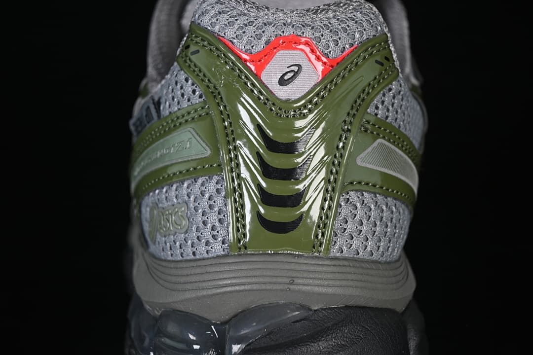Rear view highlighting gray mesh-look panels and olive-green heel overlays.