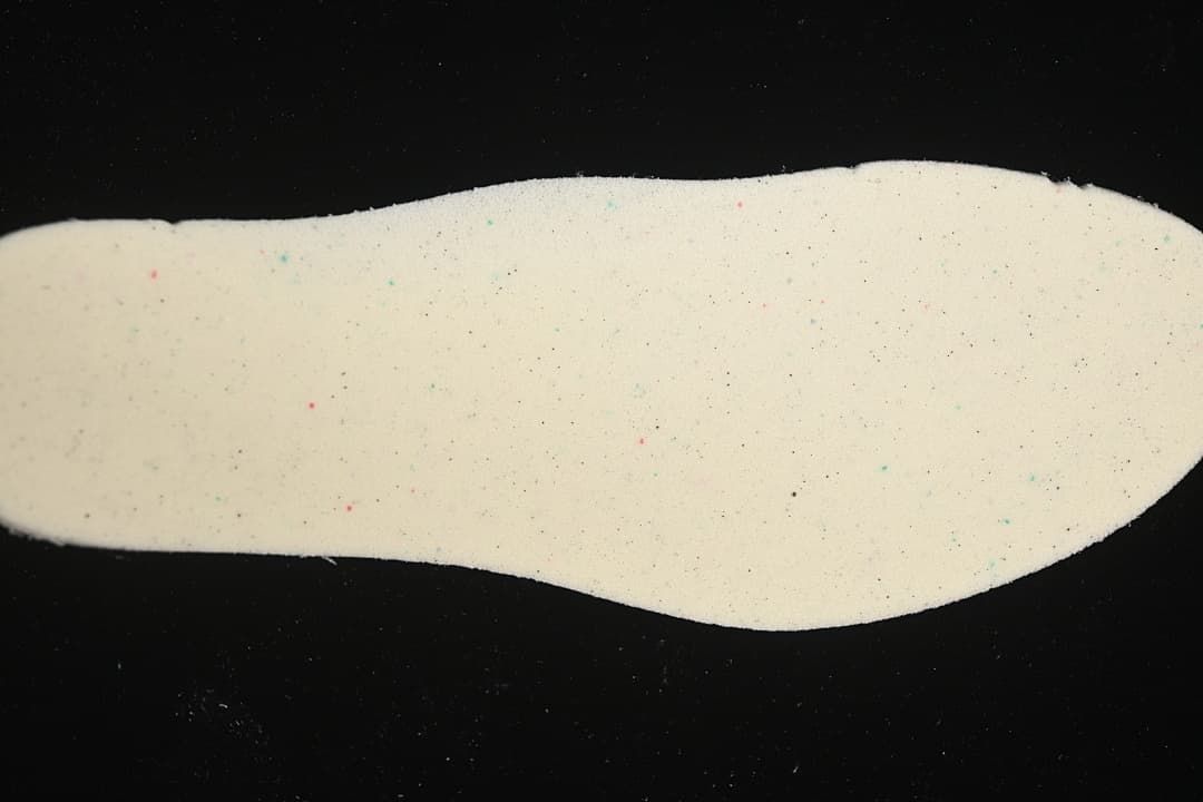 Light-colored removable shoe insole shown from above