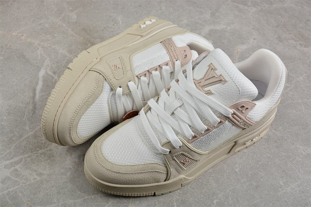 Angled view of the pair showing the beige overlays, white panels, and sculpted soles.