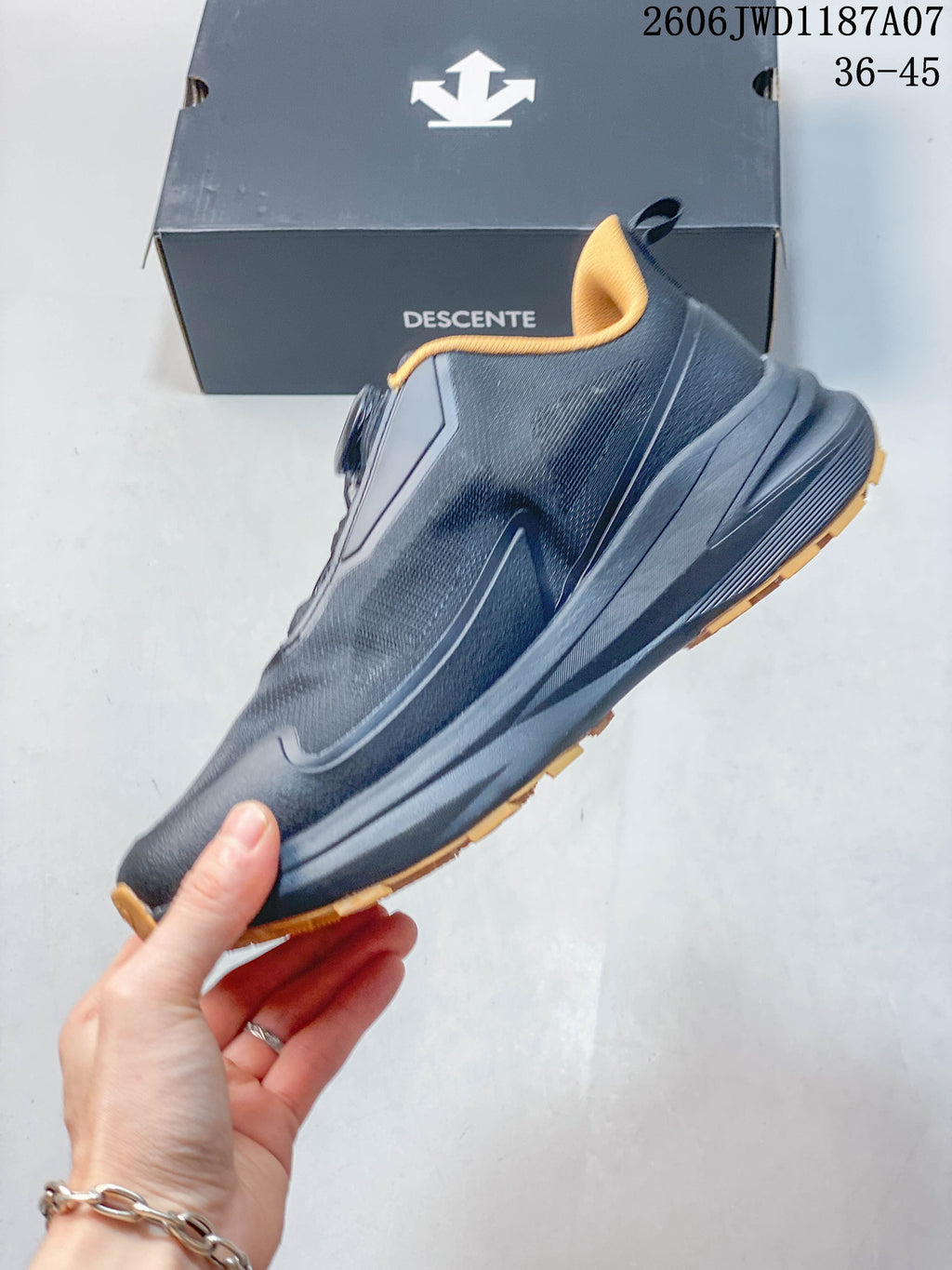 Side profile of the dark navy trail shoe with mustard-yellow outsole accents