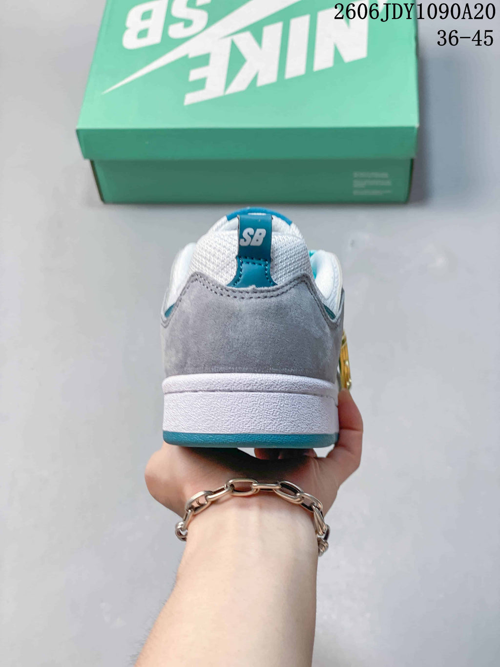 Rear view showing the gray heel, white collar, and teal accents