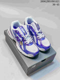 Pair of white and blue-purple New Balance 740 sneakers displayed on a shoebox