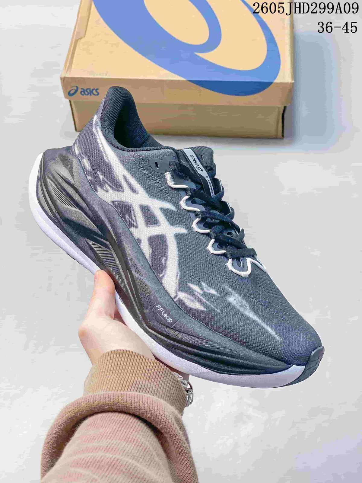 Dark gray ASICS Superblast 3 running shoe with contrasting graphics