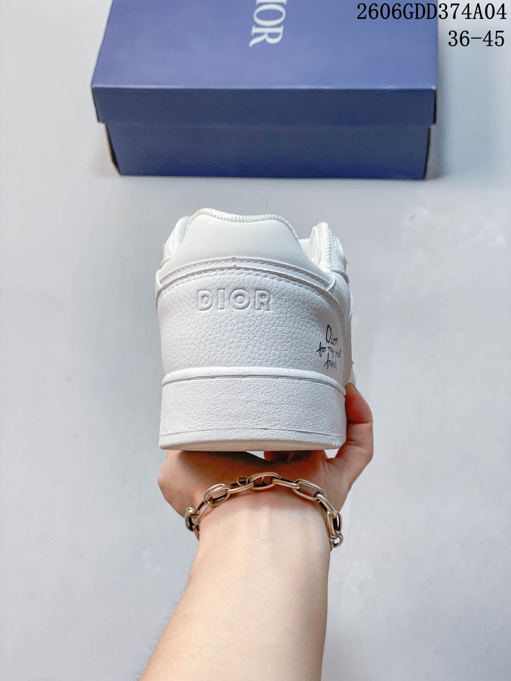 Heel view of a white sneaker with embossed branding