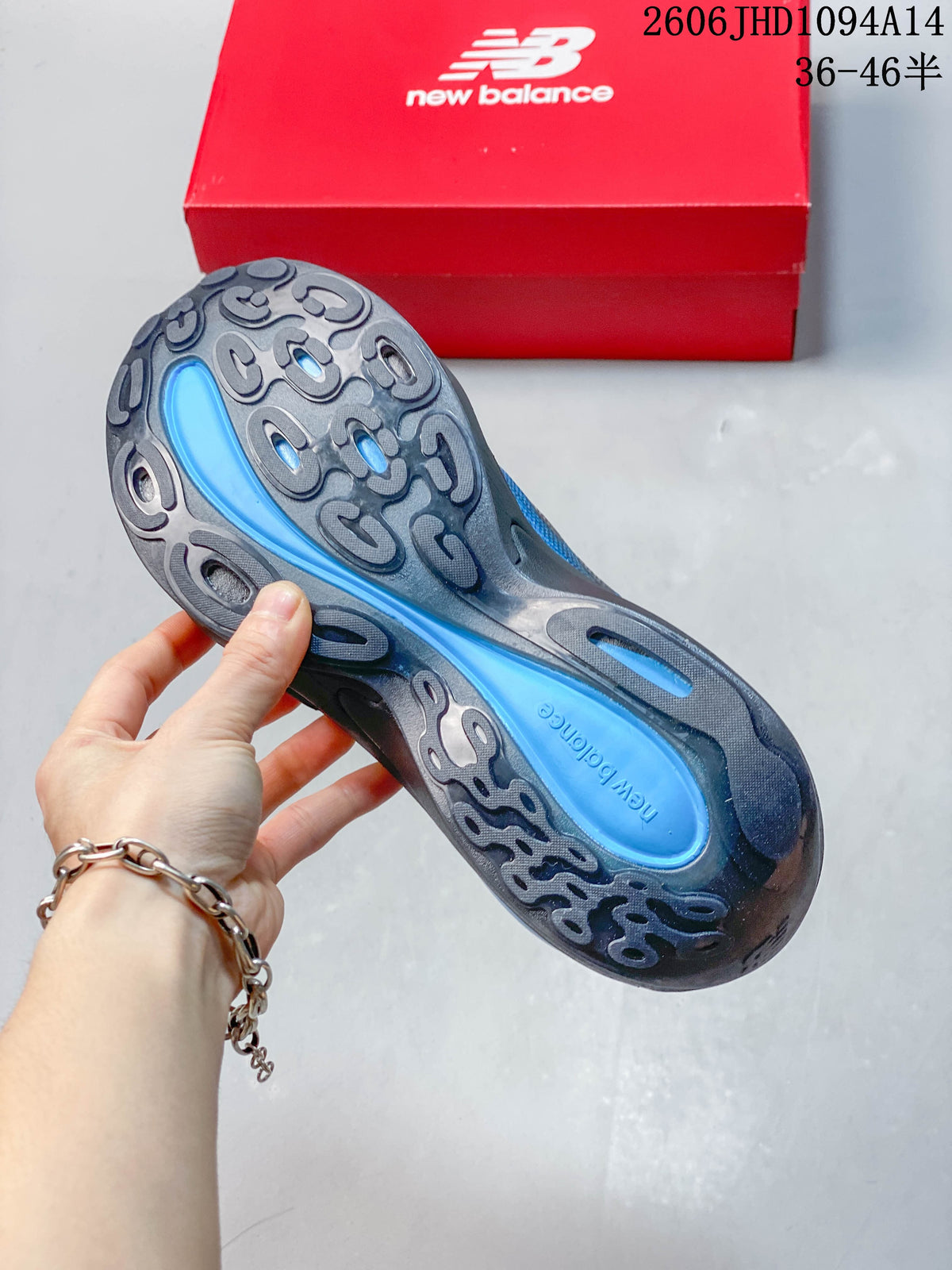 Underside of the shoe showing a dark sculpted outsole with blue inserts