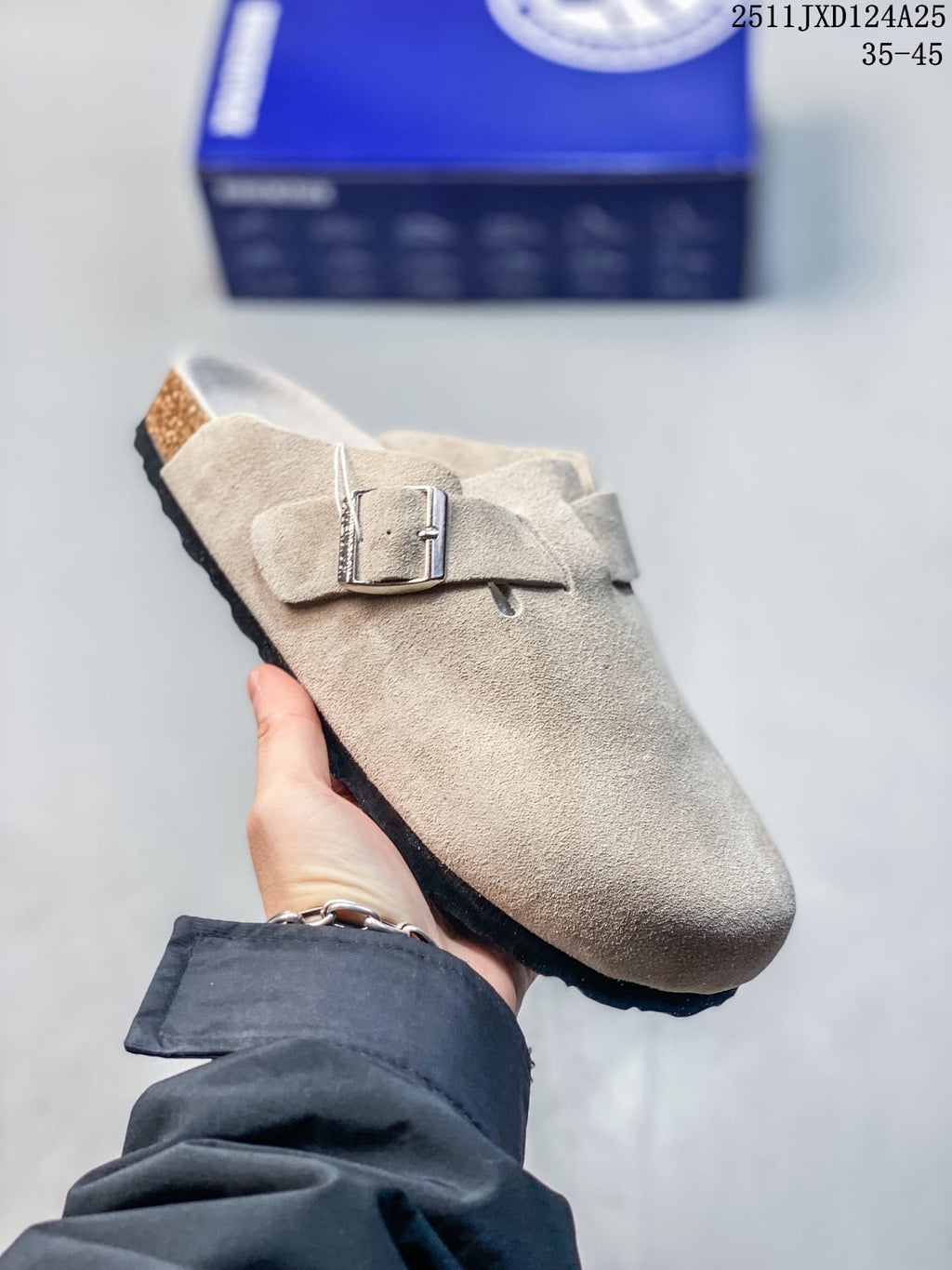 Angled side view of a taupe closed-toe clog with an adjustable metal buckle