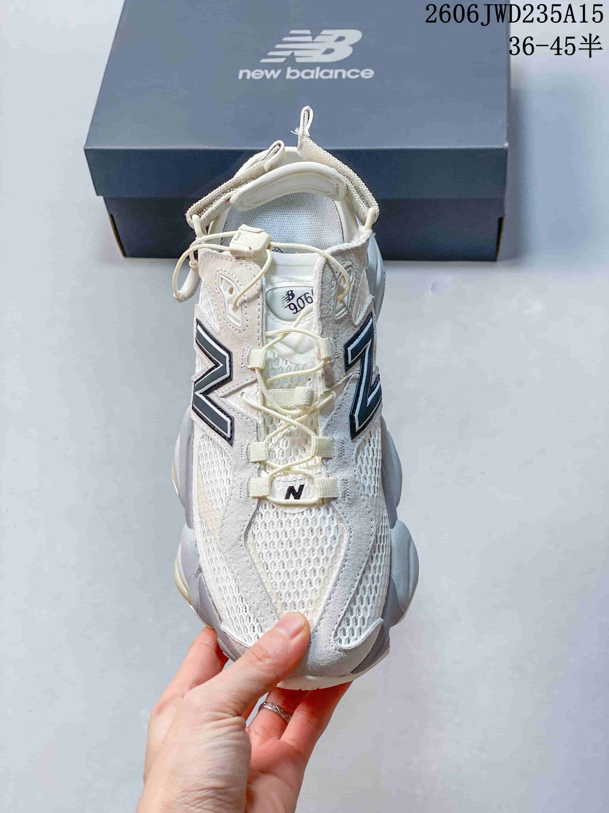 Top view of a white New Balance 9060 sneaker with cord-style lacing