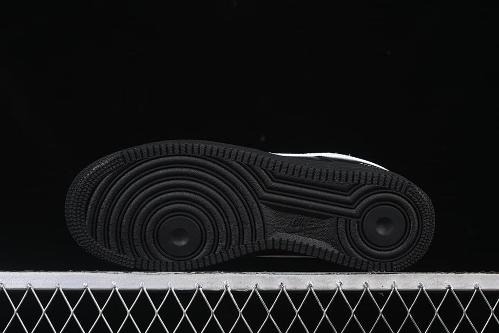 Black outsole with circular traction patterns