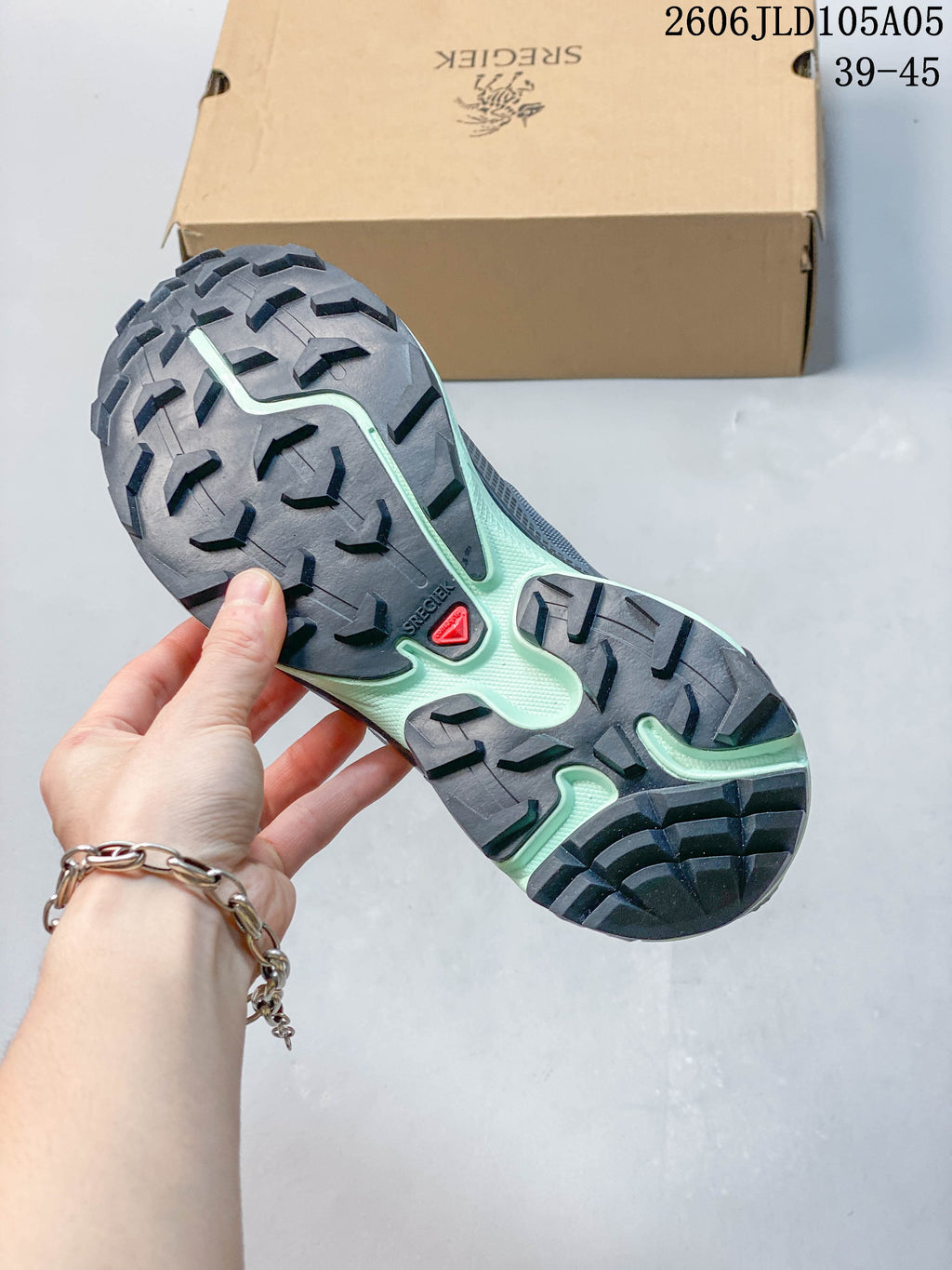 Close-up of the lugged outsole with gray and pale mint sections