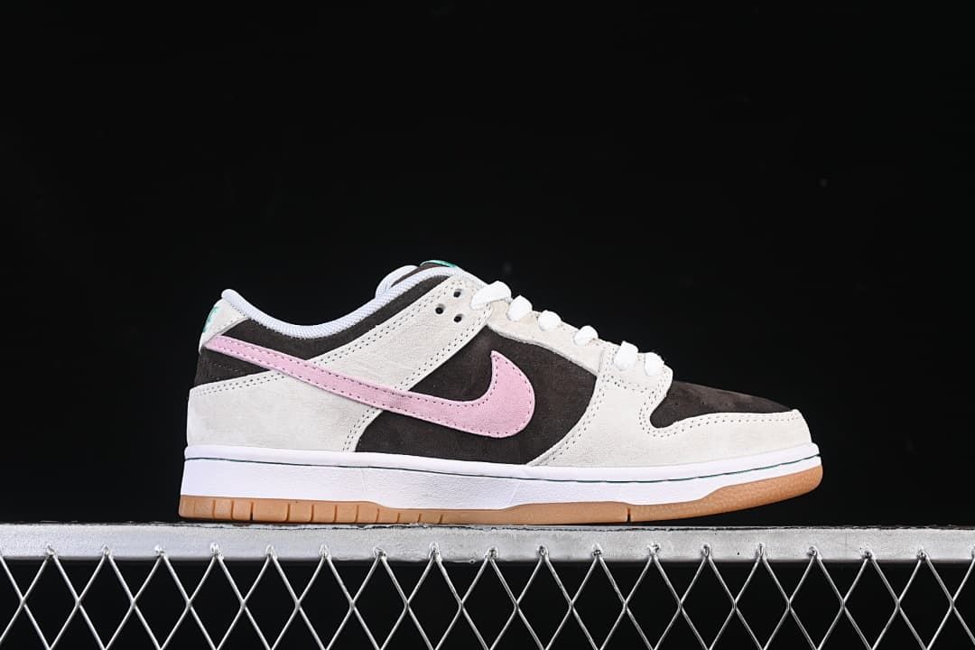 Side profile of the low-top shoe with pink Swoosh and gum outsole