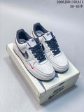 Pair of white low-top Nike Air Force 1 '07 sneakers with navy laces and red accents