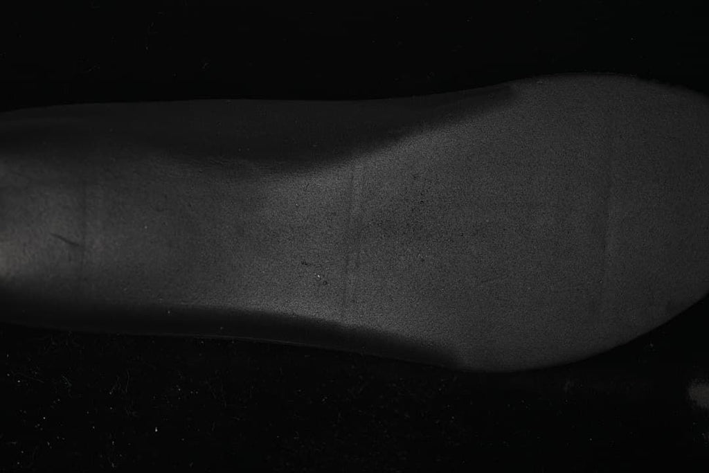 Close-up of the shoe's black textured outsole.