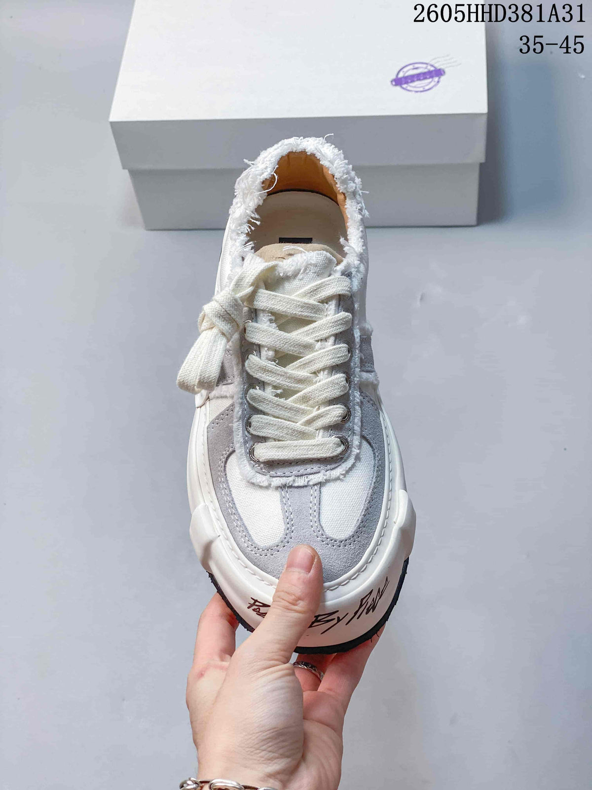 Front view of a white and gray xVESSEL low-top sneaker with lace-up fastening
