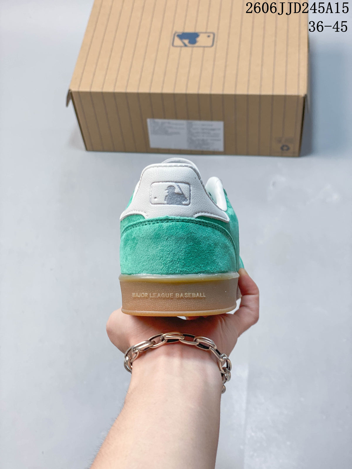 Rear view of a teal sneaker showing its white heel panel and MLB-style emblem.