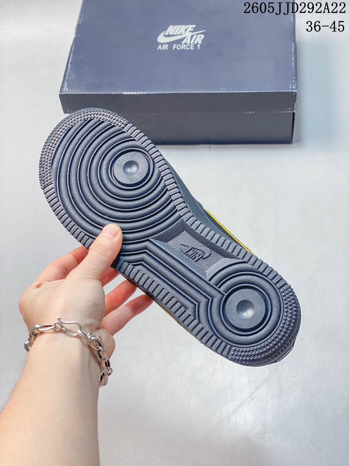 Underside view showing the circular tread pattern on a gray sneaker outsole