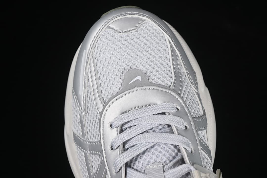 Top-down close-up of the sneaker toe and lace area