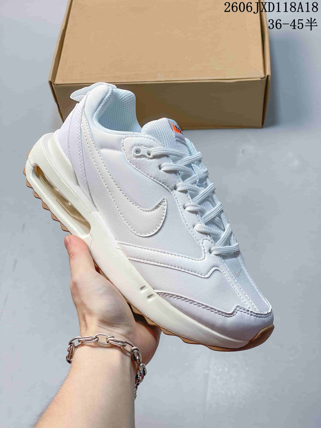 White Nike Air Max Dawn sneaker with white accents and a gum-colored outsole
