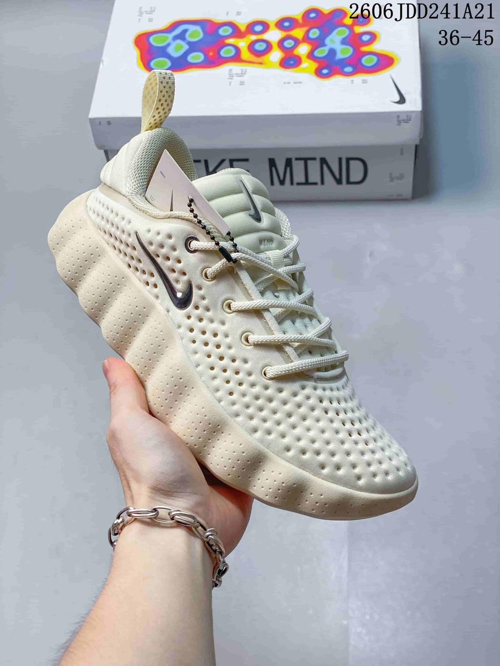 Angled side view of a cream Nike Mind sneaker