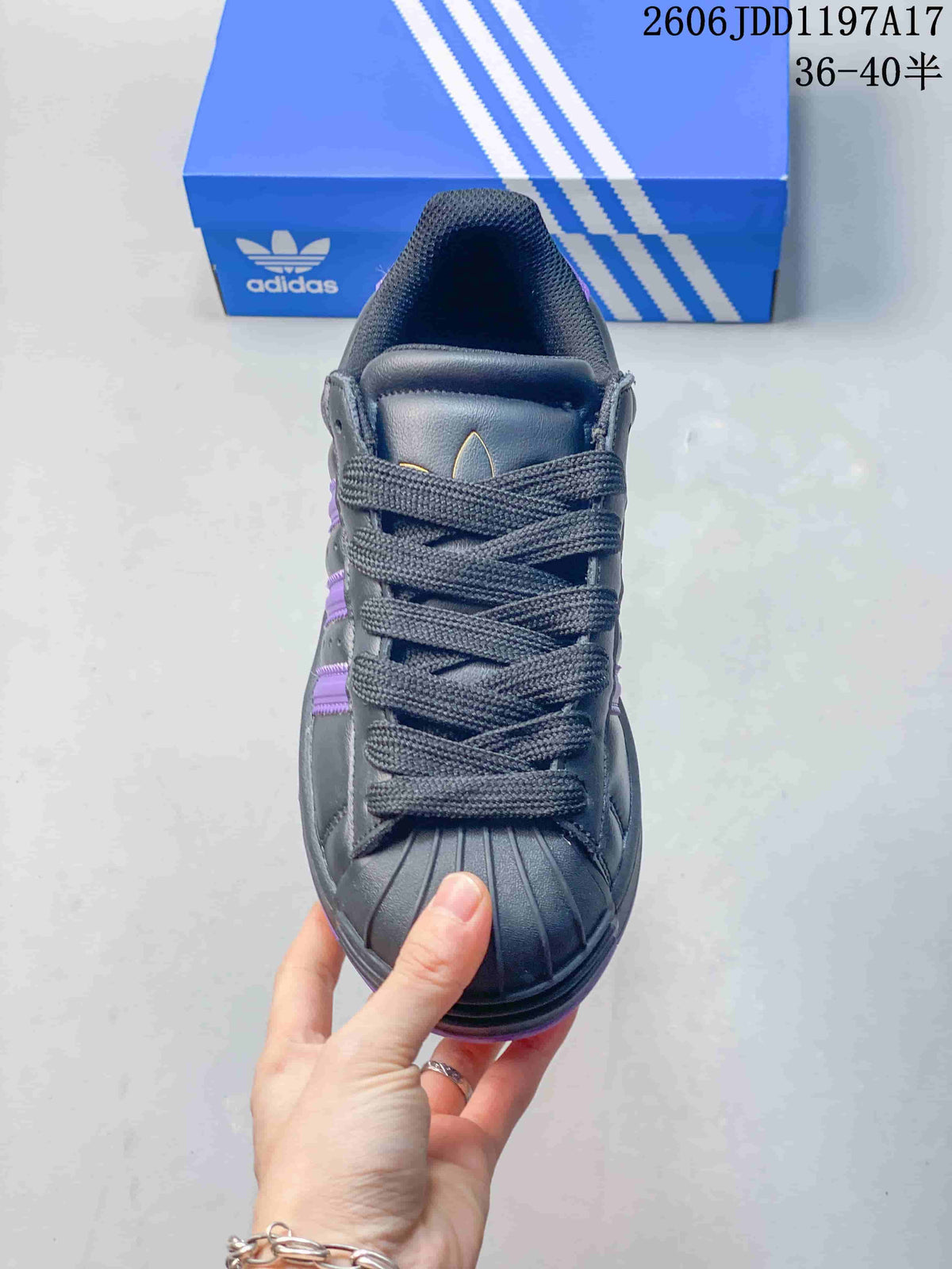 Front view of an adidas Superstar ST sneaker showing its shell toe and dark laces