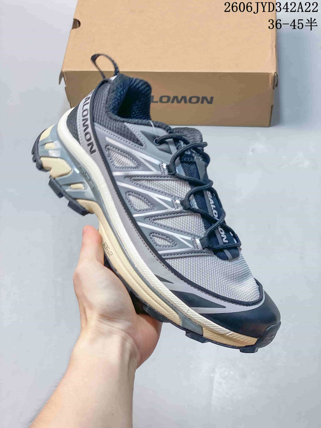 Gray and white Salomon mesh sneaker, side view