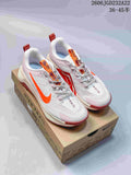 Pair of light Nike Wildhorse 10 trail-running shoes with orange and pink accents on a trail-themed box.