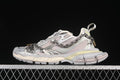 Side view of silver and grey Balenciaga 3XL sneakers with decorative chains.