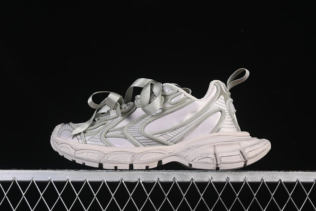 Side view of taupe Balenciaga 3XL sneakers with oversized ribbon laces