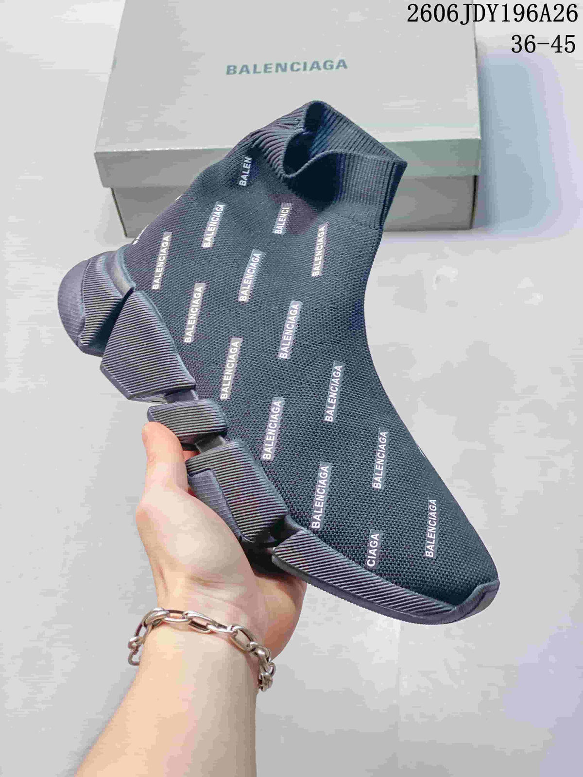 Close view of a dark gray sock-style sneaker with repeated Balenciaga branding and a segmented sole.
